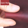 A hand is pressing a piece of dark red leather material, showing the texture and color for crafting.