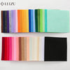 A collection of colorful non-woven felt fabric sheets in various shades and colors arranged in rows.