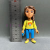 A Playful Cartoon PVC figurine of a girl with brown hair wearing a yellow shirt and blue pants.