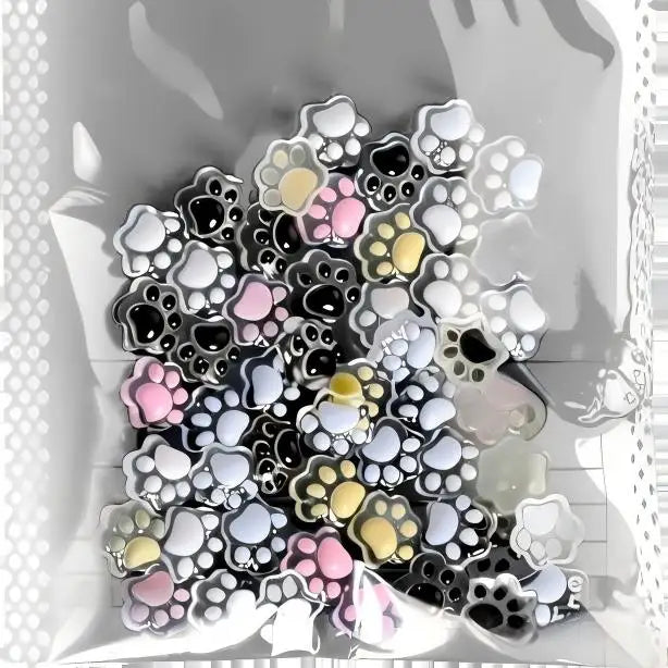 A collection of 50 luminous cat paw nail art charms in various colors and designs for DIY crafts.