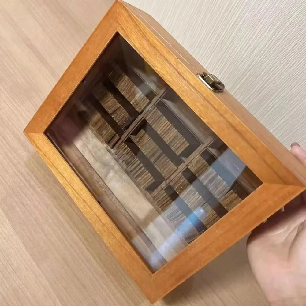 A wooden box-style shelf with a glass top displaying small strips of wood for anxiety relief or fidget use.