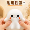 A hand is holding a white, squishy ghost-shaped stress ball for fidgeting or relaxation.