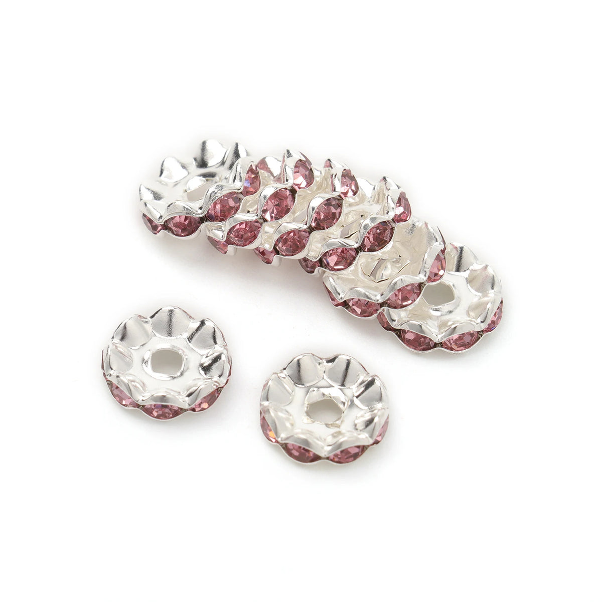 A cluster of 12mm crystal rhinestone spacer beads in pink and clear tones for jewelry making.