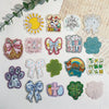 A collection of 10 glitter acrylic flatback resin cabochons featuring Easter and floral themes for DIY crafts.