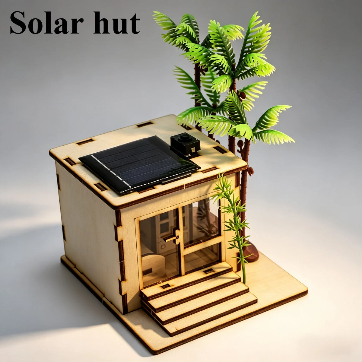 A wooden model kit of a solar hut featuring a solar panel on the roof and a small plant.