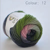 A ball of soft, hand-dyed merino wool yarn in a shade of green is shown against a white background.
