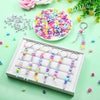 A white tray holds several heart-shaped beaded keychains with letter charms in various pastel colors.