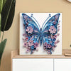 A detailed diamond painting of a blue and purple butterfly with pink floral accents on a white canvas.