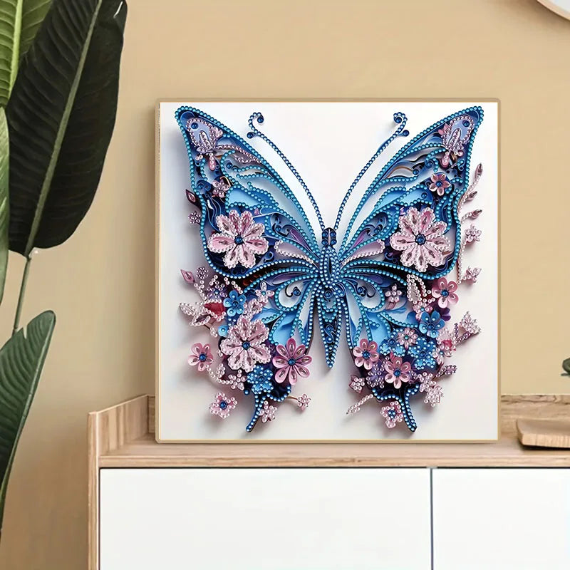 A detailed diamond painting of a blue and purple butterfly with pink floral accents on a white canvas.