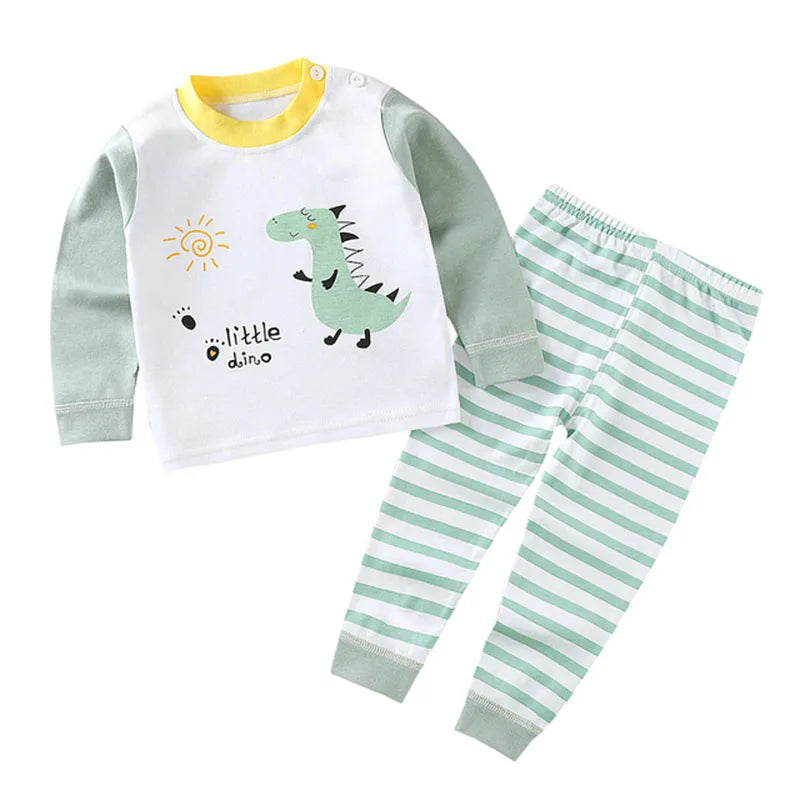 A white long-sleeve dinosaur themed pajama set for a child with yellow trim and striped pants.