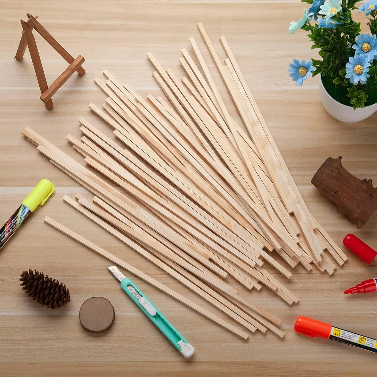 A collection of natural hardwood square dowels laid out on a wooden surface for DIY crafts and building.
