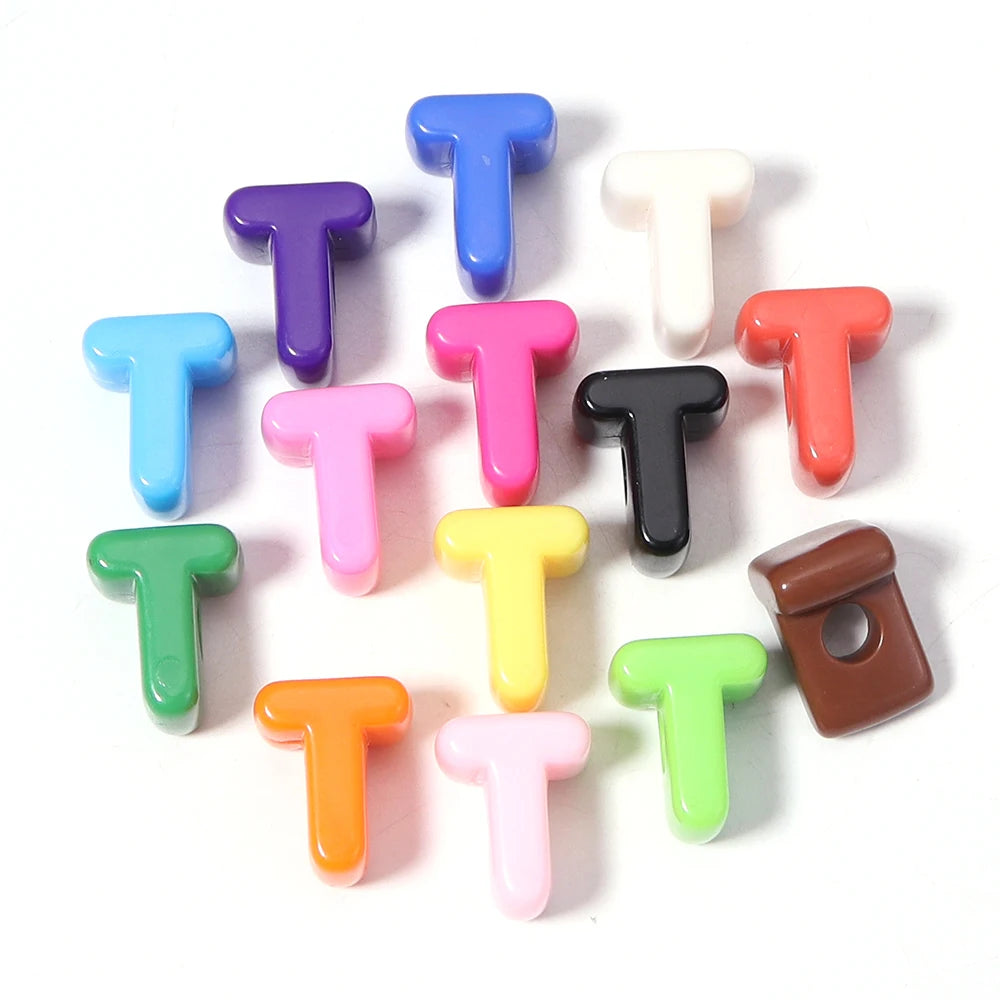 A collection of colorful acrylic letter T beads arranged in a circle.