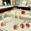 A set of five princess jewelry accessories including necklaces and heart-shaped pendants made of red and clear stones.