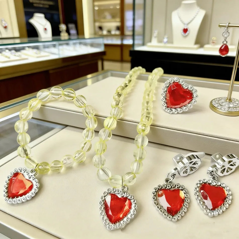 A set of five princess jewelry accessories including necklaces and heart-shaped pendants made of red and clear stones.