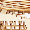 Close-up of a wooden spiral marble run DIY puzzle kit showing multiple levels and wooden components.