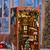 A DIY wooden book nook kit depicting a Christmas street corner scene with miniature buildings and festive decorations.
