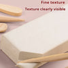 A block of white air-dry stone plastic clay is shown with a wooden tool, highlighting its fine texture.