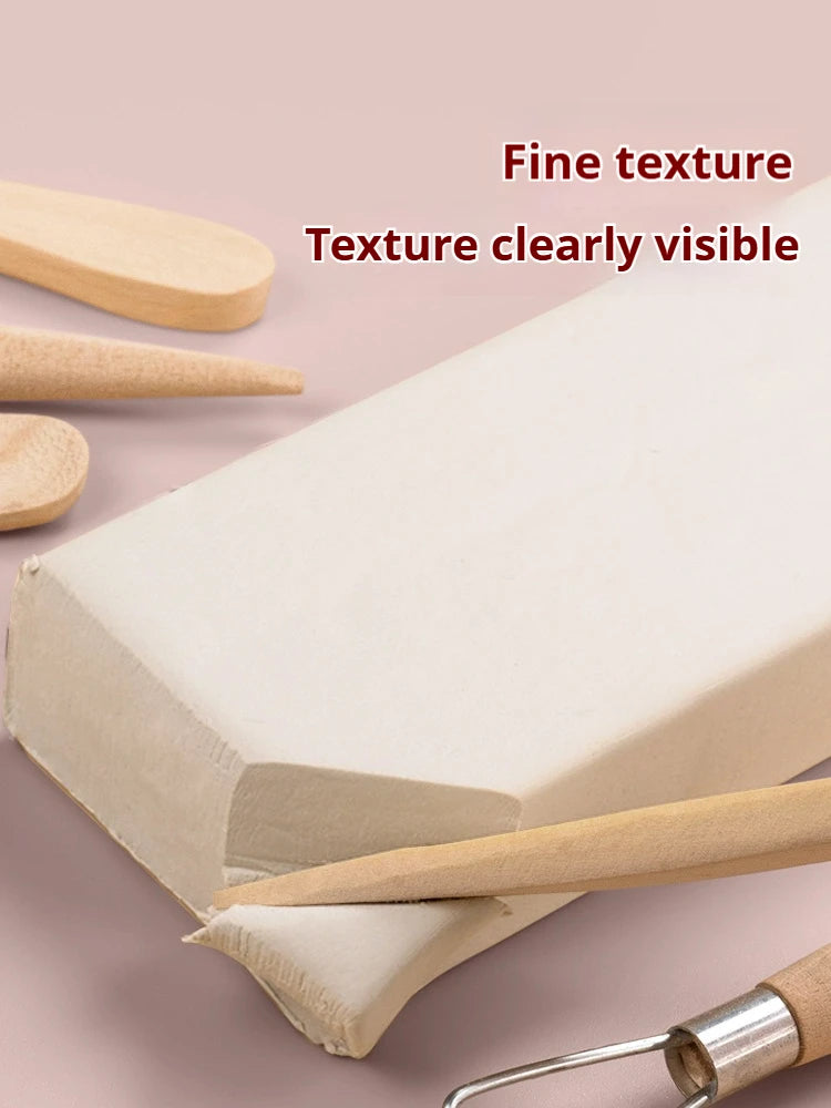 A block of white air-dry stone plastic clay is shown with a wooden tool, highlighting its fine texture.
