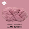 A ball of pink Merino wool yarn labeled Lirisnly's hand-picked 300g Merino.