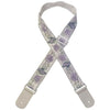 A beige woven guitar strap with purple floral embroidery and leather accents.