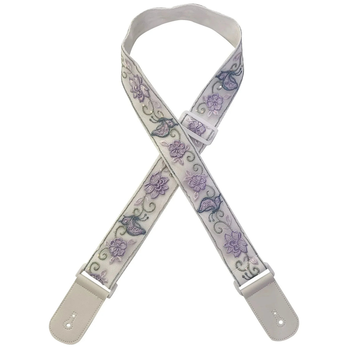 A beige woven guitar strap with purple floral embroidery and leather accents.