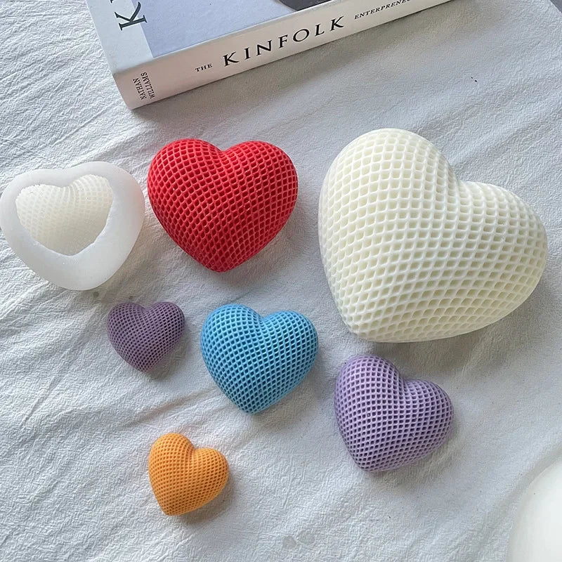 A collection of silicone heart molds in various colors including white, red, light green, blue, and purple, arranged on a whi