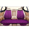 Interior view of a car seat with purple quilted cushions and beige leather upholstery.