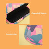 Close-up of a black velcro strap and a rounded edge detail on a pink and blue camouflage fabric product.