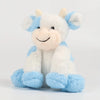 A white and light blue plush cow toy with a smiling face, sitting on a white background.