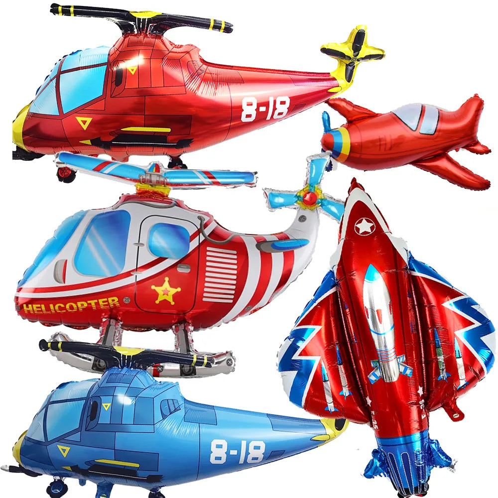 A collection of foil balloon planes in red, blue, and silver for birthday party decor.