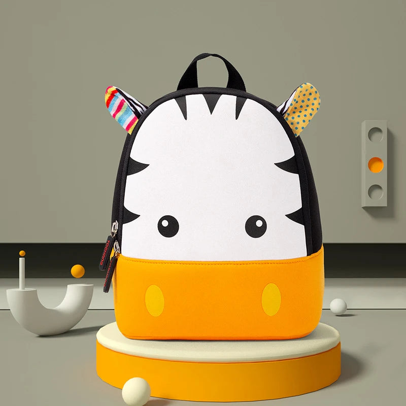 A yellow and black striped animal-themed backpack with elephant ears sits on a round orange stand.