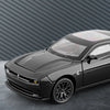 A black Dodge Challenger SRT Hellcat diecast model car is shown from a front angle against a dark gray corrugated wall.