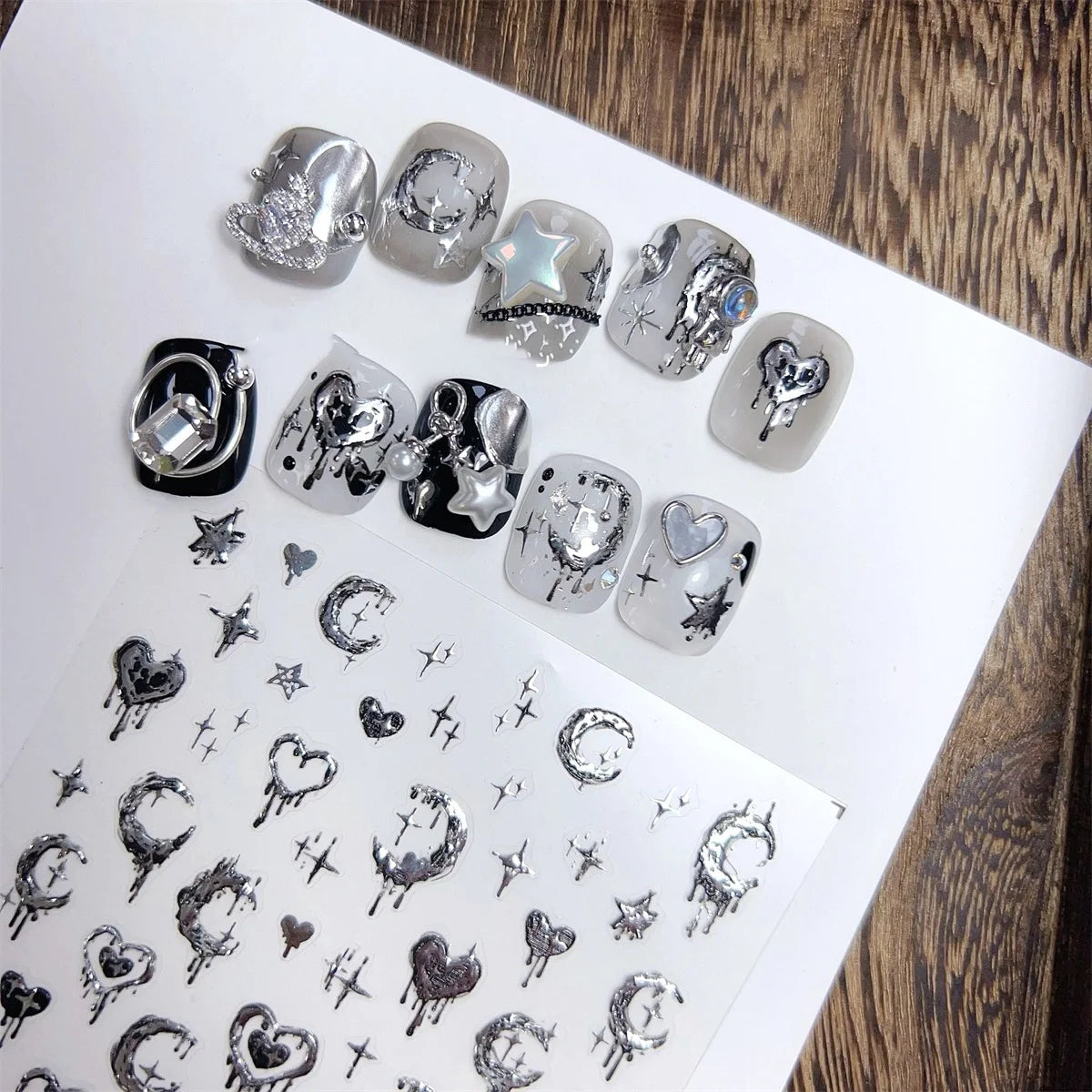 A collection of 5D bronzing gothic nail art stickers featuring skulls, hearts, and stars on a white background.