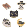 Set of four black cat enamel pins featuring various designs and styles.