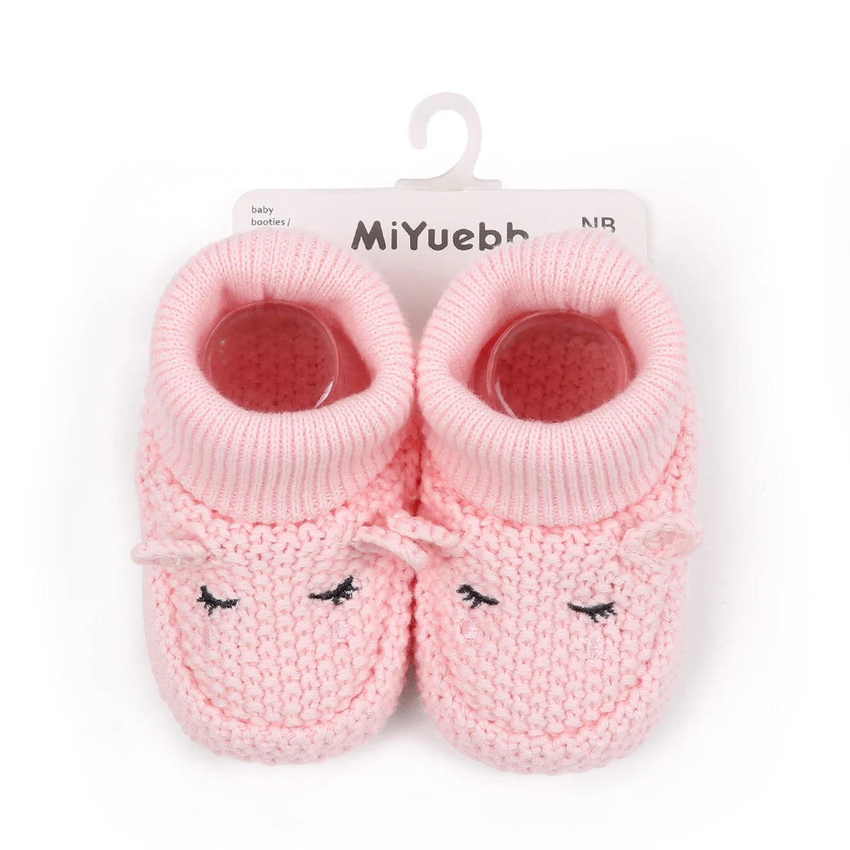 Pair of pink knitted baby booties with a cute face design