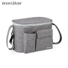 A gray Insular stroller organizer bag with a bottle holder is shown.