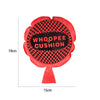 A red, flower-shaped Whoopee Cushion prank toy with a black and pink checkered pattern.