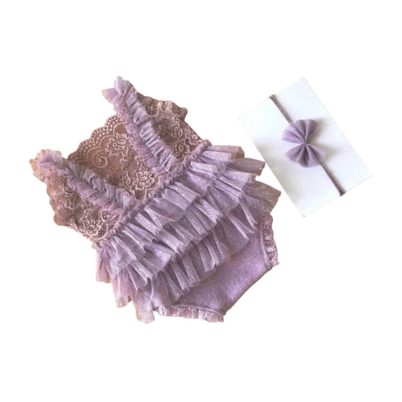A mauve lace baby romper with ruffled trim and a matching lavender fabric headband.