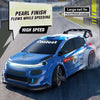 Blue RC drift car with pearl finish coating driving on a road, featuring LED lights and a large tail fin.