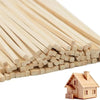 A close-up view of natural hardwood square dowels stacked in a fan-like arrangement next to a small wooden house model.