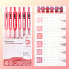 A set of six retractable gel pens in various colors, including red and pink shades, shown alongside a grid for measuring.