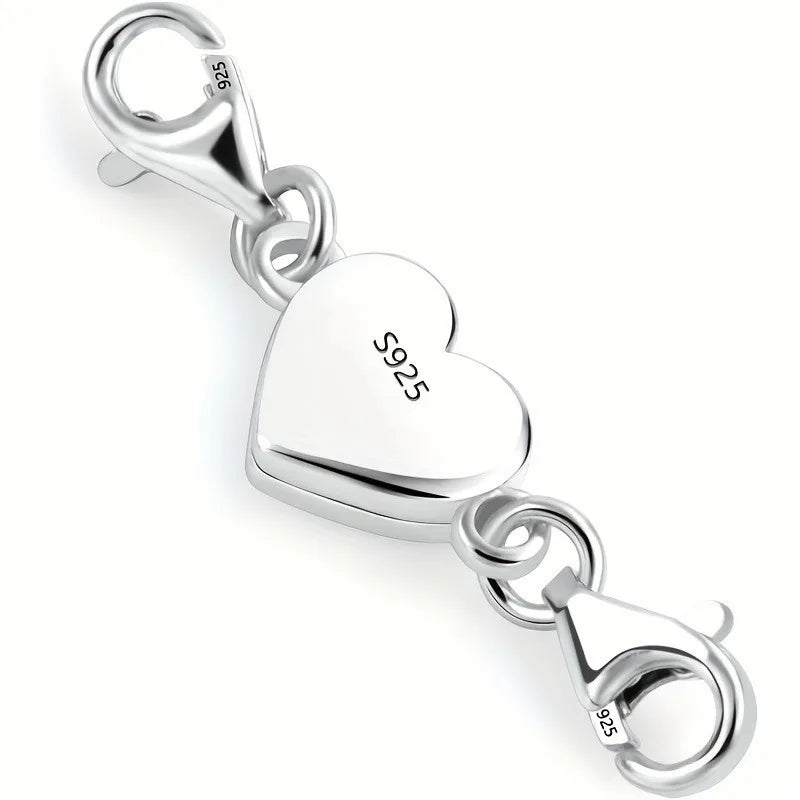 Silver heart-shaped magnetic clasp necklace with a bail and jump ring.