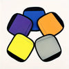 Five colored neoprene luggage handle covers in purple, blue, orange, yellow, and gray.