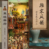 A DIY book nook kit featuring a detailed miniature scene with LED lighting and a traditional Chinese scroll design.