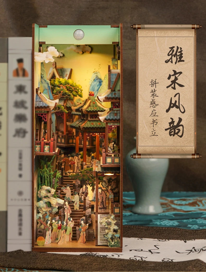 A DIY book nook kit featuring a detailed miniature scene with LED lighting and a traditional Chinese scroll design.