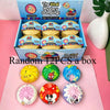 A box of viral mystery dumpling squishies featuring various cartoon patterns and colors.