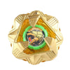 A gold metal spinning top with a faceted design and a green center.