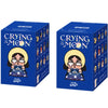 A blue box for a Crybaby Crying to the Moon collectible figurine featuring a woman with a yellow halo and tears.