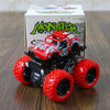 A red and black friction-powered monster truck toy sits in front of its packaging box.