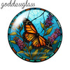 Round glass cabochons featuring an orange butterfly and purple flowers set in a blue background.